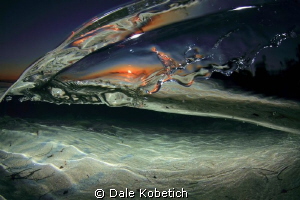 disturbance in a tide pool at sunset by Dale Kobetich 